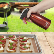 Hand spraying oil onto food using Evo Stainless Steel Oil Sprayer, showcasing precise, non-aerosol application for healthier cooking.