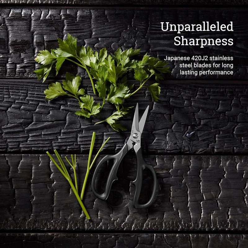 Shun | Shear Set, 2-Piece: Overhead view of parsley and black-handled kitchen shears showcasing their sharp, durable Japanese 420J2 stainless steel blades on charred wood surface.