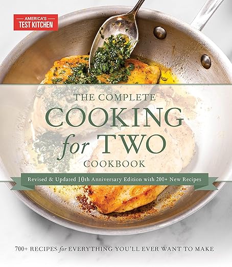 Cover of The Complete Cooking for Two Cookbook featuring a skillet with two pieces of golden-brown chicken topped with herb sauce, highlighting 700+ recipes for two.