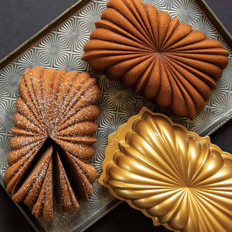 Nordic Ware | Classic Fluted Loaf Pan on a tray, showcasing its elegant starburst flutes, ideal for crafting stunning quick breads and cakes.