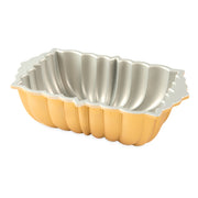 Nordic Ware | Classic Fluted Loaf Pan close-up, showcasing its durable cast aluminum construction and elegant starburst flutes, ideal for creating stunning baked goods.