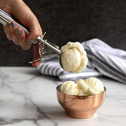 A hand using the Nordic Ware Large Cookie Dropper to scoop ice cream, showcasing its practical use for desserts.