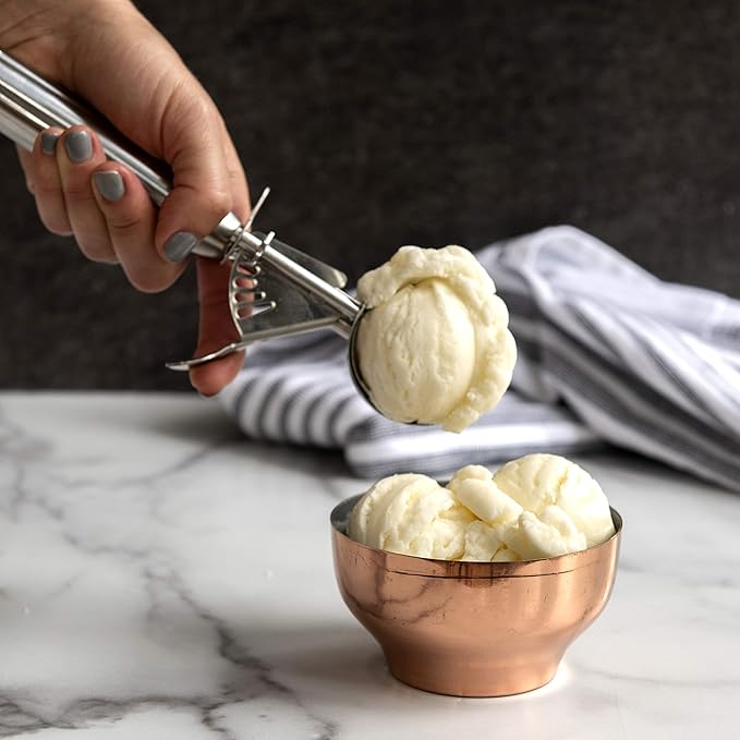 A hand using the Nordic Ware Large Cookie Dropper to scoop ice cream, showcasing its practical use for desserts.