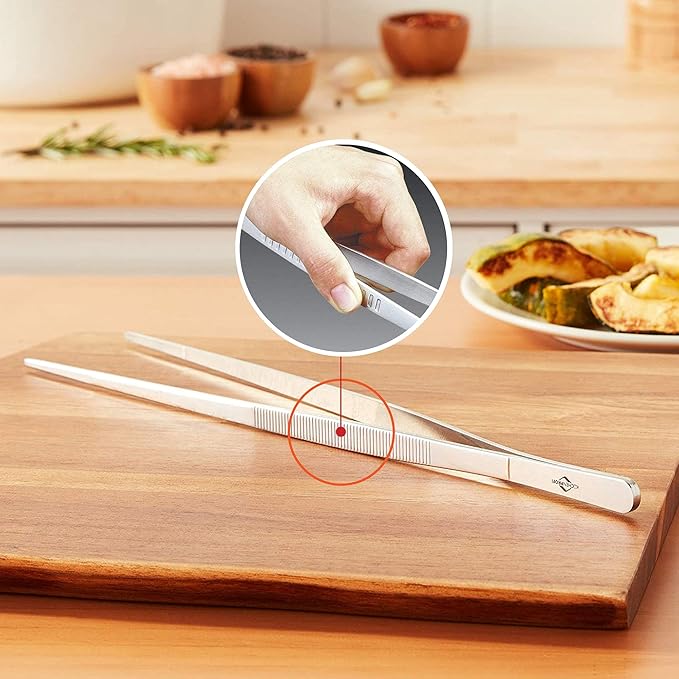 Küchenprofi | Tweezer Tongs, 8.75 displayed on a cutting board, ideal for precise kitchen tasks like serving sushi or flipping tortillas.