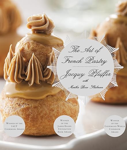 Cover of “The Art of French Pastry” cookbook featuring stacked choux-pastry puffs, highlighting award-winning techniques by Jacquy Pfeiffer.