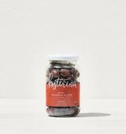 Kosterina - Spicy Kalamata Olives jar on a white surface, featuring a label detailing the product's spicy and rosemary-infused olives.