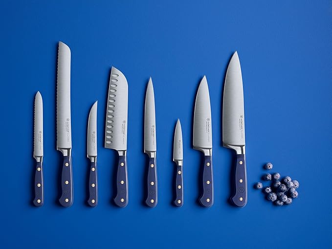 Wüsthof Classic 6 Utility Knife Wild Blueberry, shown alongside blue balls, highlighting its sleek blade and functionality for versatile kitchen use.