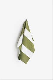 Striped linen tea towel with a hanging loop, eco-friendly and absorbent, part of MagicLinen's zero-waste program, designed for kitchen use.