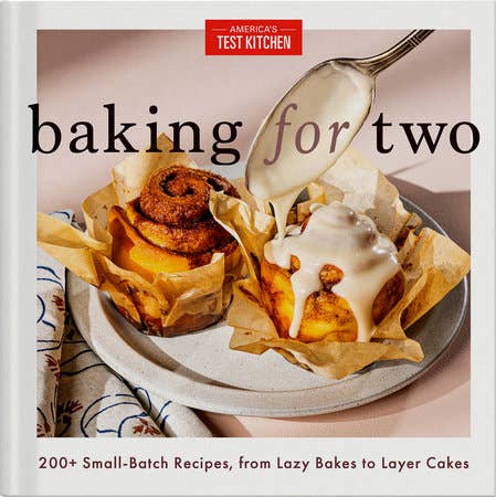 “Baking for Two” cookbook cover featuring cinnamon rolls with icing, highlighting over 200 small-batch recipes ideal for intimate baking experiences from America’s Test Kitchen.
