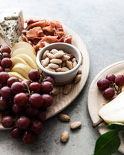 Farmhouse Pottery - Petite Silo Bowl: Single, holding whole almonds amidst a charcuterie spread with grapes, pears, cheese, and cured meat on wooden boards.