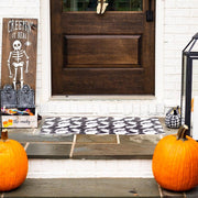 Carolina Creekhouse - Fab-Boo-Lous FloorFlat mat in front of a Halloween-themed door, featuring a ghost pattern and surrounded by pumpkins and festive decor.