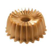 Nordic Ware | Brilliance 10-Cup Bundt Pan, featuring a gold finish with a central hole, ensuring even baking and easy cake release.
