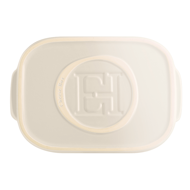Emile Henry Cheese Box, Black: Top-down view of a cream ceramic container with embossed lid, designed for storing cheese with practical side handles.