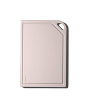 Pale-pink MK Free Board™️ with rounded corners, juice groove, and handle. Plant-based, non-porous, perfect for raw proteins; ideal for diverse culinary tasks.