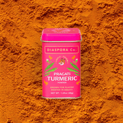 Diaspora Co. Spices - Pragati Turmeric: 185g Chef Tin, featuring a pink container with white text and a tiger logo, sourced from heirloom turmeric.