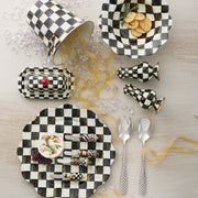 Courtly Check Butter Box by MacKenzie-Childs displayed in a checkered tabletop setting with matching kitchenware, emphasizing its hand-painted design and elegant brass accents.