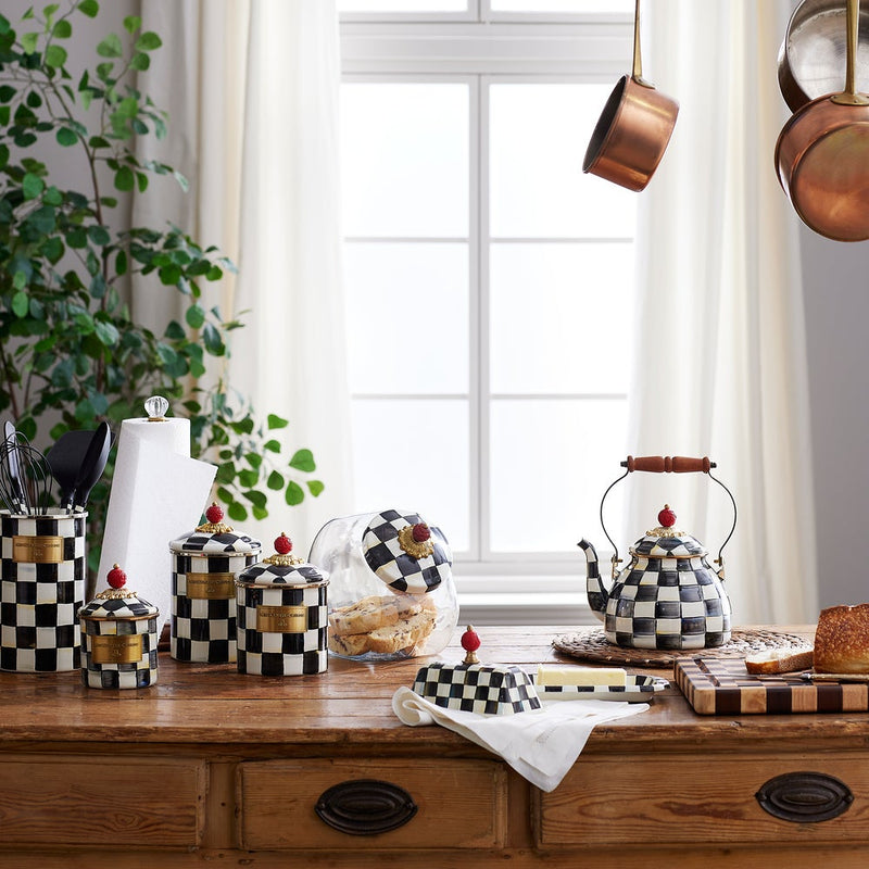 MacKenzie-Childs Courtly Check Butter Box on rustic counter with bread, cookies, and copper pans, showcasing a cozy Athens Cooks kitchen scene.