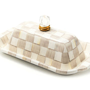 MacKenzie Childs | Mocha Check Butter Box, a ceramic dish with lid, hand-painted in beige-and-cream checks, features a clear glass knob with a gold-tone ring.