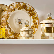 MacKenzie Childs | Mocha Check Lidded Sugar Bowl displayed with hand-painted checks, brass accents, and glass knob on a shelf with decorative bee-themed platter and canisters.