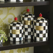 MacKenzie Childs | Courtly Check Small Canister set featuring a hand-painted checkerboard pattern with red finials, ideal for versatile kitchen or home storage.