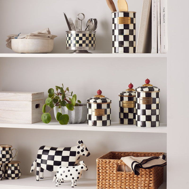 MacKenzie Childs | Courtly Check Small Canister styled on a kitchen shelf with other matching checkered ceramics and utensils, showcasing its decorative and functional versatility.