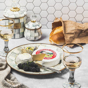 MacKenzie Childs | Sterling Check Small Canister with crystal knob displayed alongside wine, cheese platter, and fresh bread, showcasing elegant kitchen essentials for Athens Cooks.