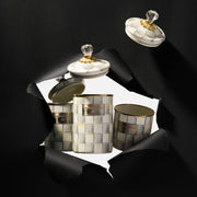 MacKenzie-Childs Sterling Check Small Canister with mother-of-pearl pattern, gold rims, and crystal knob, displayed against torn black paper, ideal for kitchen storage.