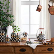 MacKenzie Childs | Courtly Check Medium Canister on a kitchen counter, hand-painted with signature checks and topped with a faux-cinnabar knob, perfect for versatile storage.