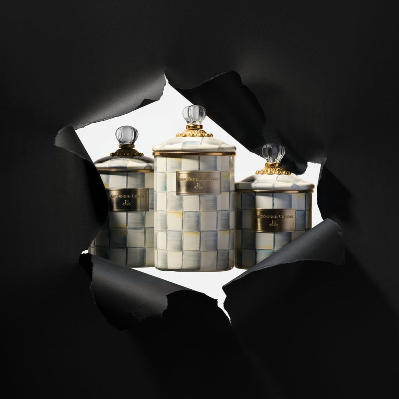 MacKenzie Childs | Sterling Check Medium Canister with hand-painted grey checks, glass knob, and gold-tone trim, revealed through black paper, ideal for versatile kitchen storage.
