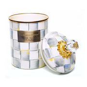 MacKenzie-Childs Sterling Check Medium Canister with hand-painted checks, brass-tone nameplate, gold-tone floral lid collar, and clear glass knob beside it.