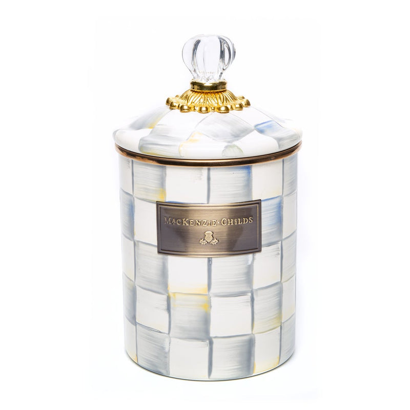 MacKenzie Childs | Sterling Check Medium Canister features a hand-painted checker pattern, a fluted lid with glass knob, and a gilded band, ideal for kitchen storage.