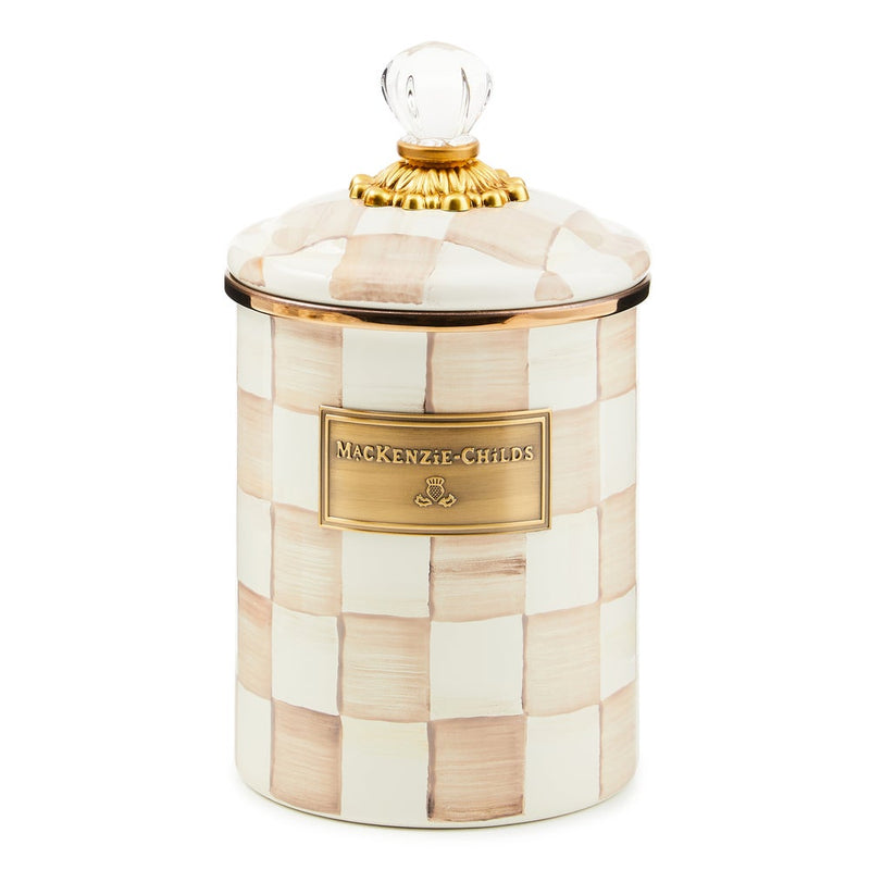 MacKenzie Childs | Mocha Check Medium Canister features hand-painted cream and beige checks, a brass nameplate, and a domed lid with an ornate gold-tone fitting.