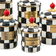 MacKenzie Childs | Courtly Check Large Canister: Decorative storage canisters with hand-painted black-and-white check pattern, gold trim, and red finial lids, ideal for versatile kitchen storage.