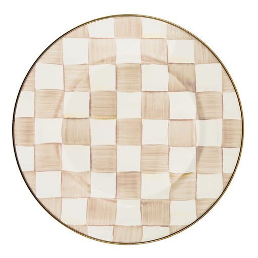 MacKenzie Childs | Mocha Check Dinner Plate features a hand-painted beige and off-white checkerboard pattern with a bronzed stainless steel rim, exemplifying artisanal craftsmanship.