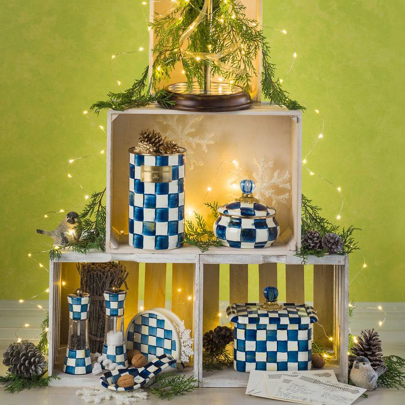 MacKenzie Childs Royal Check Wood Paper Towel Holder with blue and white checkered enamel, wood base, stainless-steel post, and blue glass finial displayed with recipe cards.