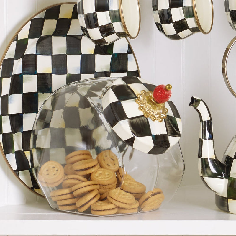 MacKenzie Childs Cookie Jar with Courtly Check Lid on a shelf, filled with cookies, alongside a matching plate, teapot, and mugs.