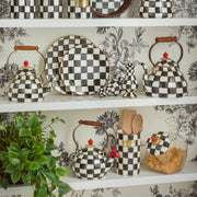 MacKenzie Childs | Cookie Jar with Courtly Check Lid displayed on open shelves, featuring black-and-white checkerboard ceramics, enhancing kitchen decor with style and function.