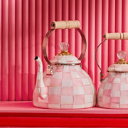 MacKenzie Childs | Rosy Check Tea Kettle, 3 QT, featuring a pink-and-white checkerboard design, wooden handle, and crystal-style knob, displayed on a shelf.
