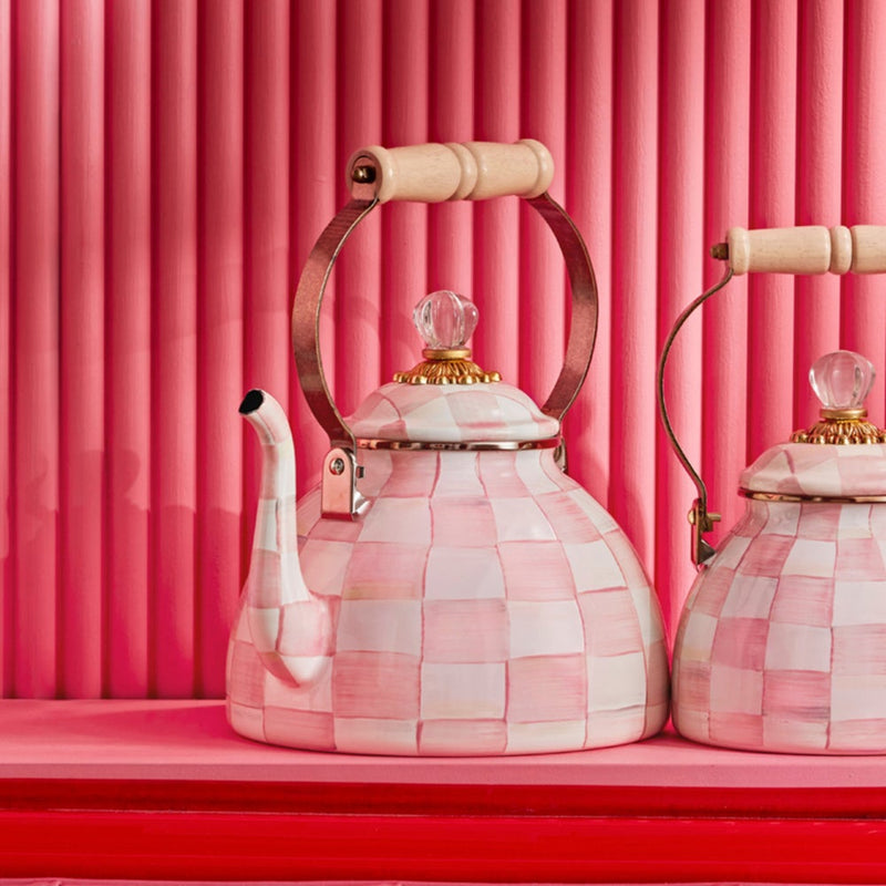 MacKenzie Childs | Rosy Check Tea Kettle, 3 QT, featuring a pink-and-white checkerboard design, wooden handle, and crystal-style knob, displayed on a shelf.