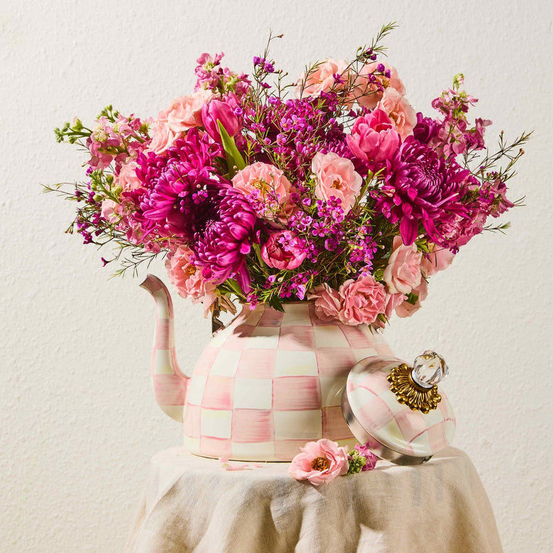 MacKenzie-Childs | Rosy Check Tea Kettle, 3 QT, repurposed as a vase with pink blooms, showcasing its hand-painted checkerboard pattern and elegant design.
