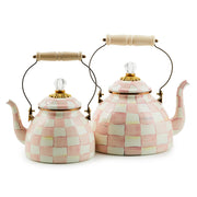 MacKenzie Childs | Rosy Check Tea Kettle, 3 QT features a pink-and-white checkerboard pattern, clear glass knob, and curved wood-handled spout.