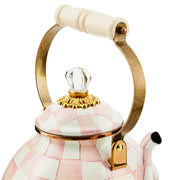 MacKenzie Childs | Rosy Check Tea Kettle, 3 QT: Decorative ceramic teapot with pink-white checks, brass-finished handle, wood grip, and glass knob, showcasing artisan elegance.