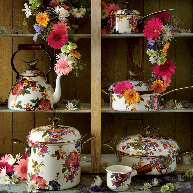 MacKenzie Childs White Flower Market with Bird Tea Kettle, 3 QT, on rustic shelf, surrounded by matching floral cookware and fresh blossoms, embodying playful elegance.