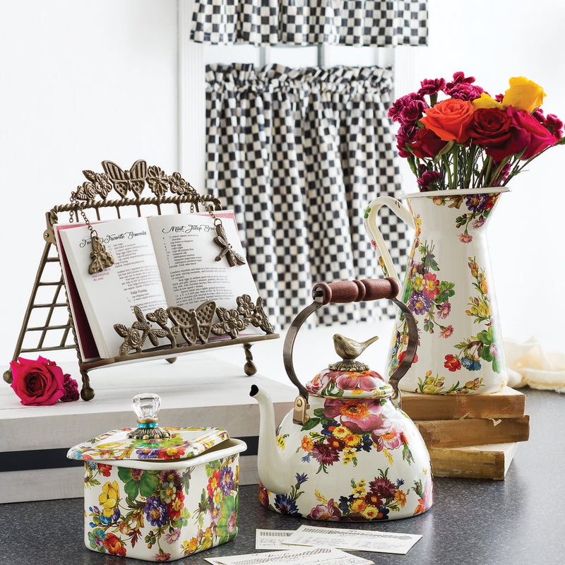 MacKenzie Childs | White Flower Market with Bird Tea Kettle, 3 QT, adorned with floral patterns and a bird figurine lid, displayed in a curated kitchen setting.