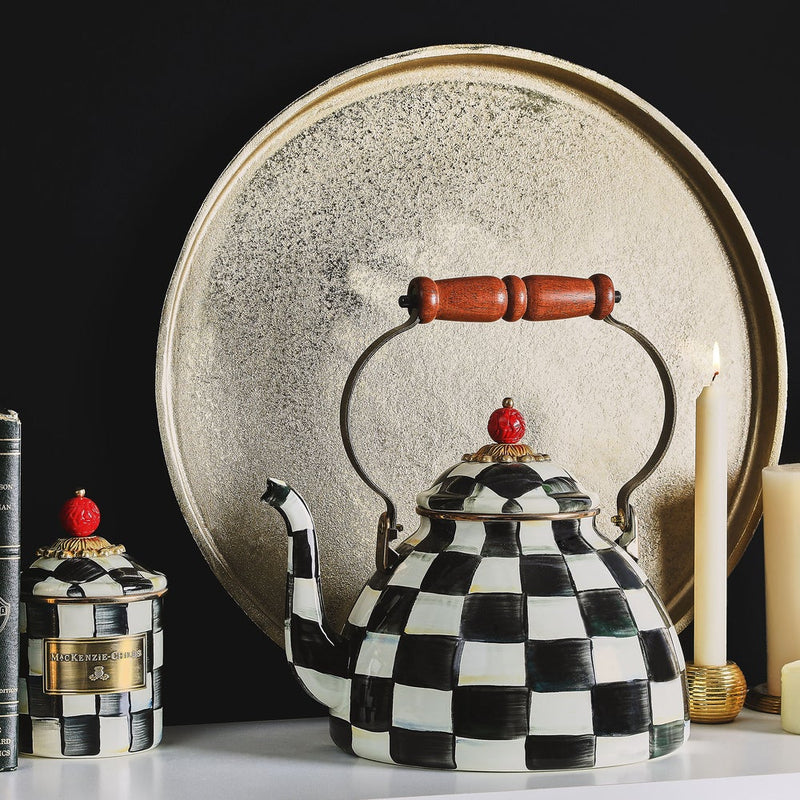 MacKenzie Childs | Courtly Check Tea Kettle, 3 QT., displayed with matching jar, books, gold tray, and candles, showcasing Athens Cooks' whimsical kitchen style.