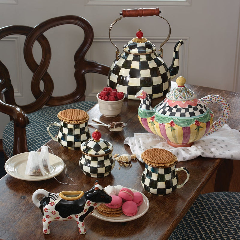 MacKenzie Childs | Courtly Check Tea Kettle, 3 QT, elegantly displayed among matching mugs, sugar bowl, and a colorful teapot, exemplifying Athens Cooks' curated kitchen style.