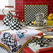MacKenzie Childs | Courtly Check Tea Kettle, 3 QT, displayed on a styled countertop with matching checkered tea set, showcasing its elegance and whimsy.