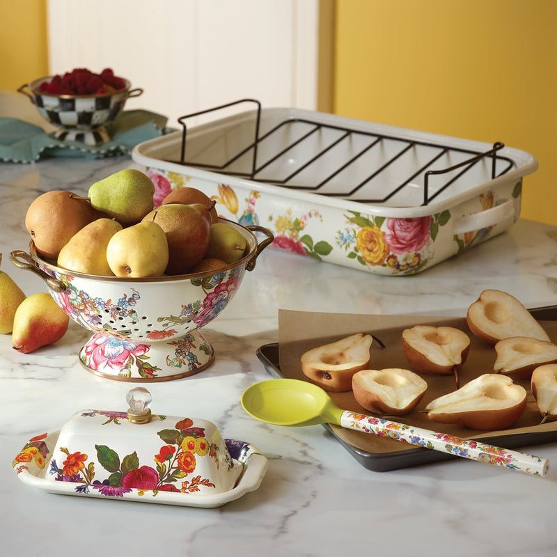 MacKenzie-Childs White Flower Market Large Colander filled with pears on a marble countertop, complemented by matching floral kitchenware, showcasing elegant kitchen prep essentials.