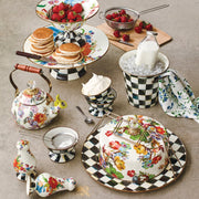 MacKenzie-Childs Courtly Check Ice Cream Dish holds whipped cream in a stylized brunch spread with floral-and-checkered ceramics, enhancing the elegant tabletop presentation.