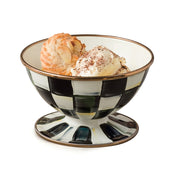 MacKenzie-Childs | Courtly Check Ice Cream Dish with vanilla ice cream and macaroon, featuring a black-and-white checkered pattern and gold rim, showcasing elegant dessert presentation.